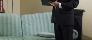 Claims adjuster standing in flooded living room
